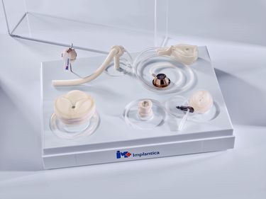 Prototypes box open containing RefluxStop™, Swedish Adjustable Gastric Band (SAGB) and early prototypes of UriControl® (1 male, 1 female), RectalRestore®, StomaRestore®